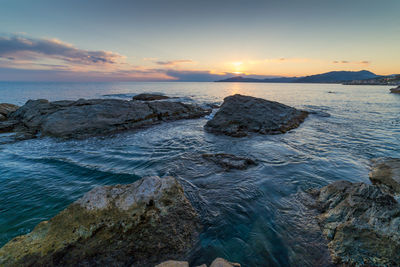 Scenic view of sea against sky at sunset