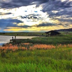 Scenic view of landscape against cloudy sky