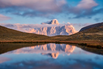 Scenic view of lake and mountains against sky