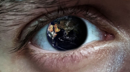 Digital composite image of planet earth reflecting on iris