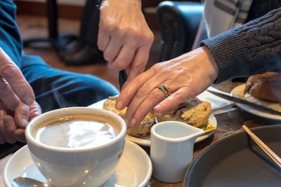 Close-up of people in cup on table