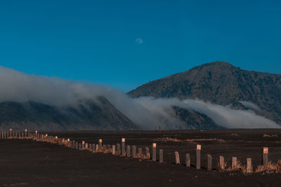 Scenic view of snowcapped mountains against blue sky