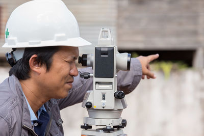 Close-up of surveyor working outdoors