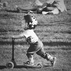Boy playing on grassy field