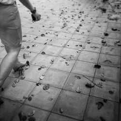 Low section of person standing on tiled floor