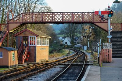 Railroad tracks amidst buildings against sky