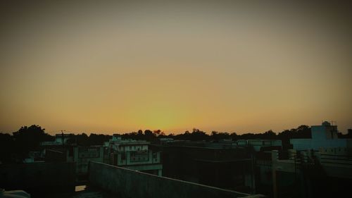 Built structure against clear sky at sunset