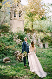 Rear view of couple standing on landscape