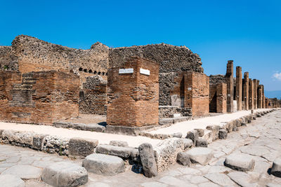 Old ruin building against blue sky