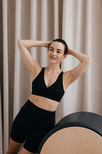 Portrait of young woman exercising in gym