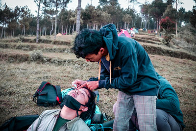 Friends lying on land