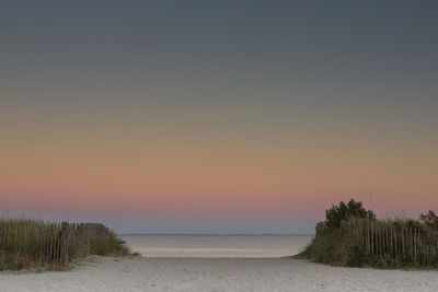 Scenic view of sea against clear sky during sunset