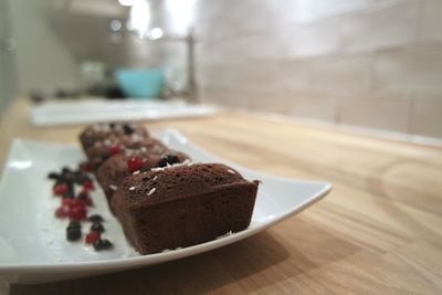 Close-up of chocolate brownies in plate on table at home