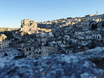 Buildings in town against clear blue sky