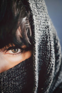 Close-up portrait of woman face covered with scarf