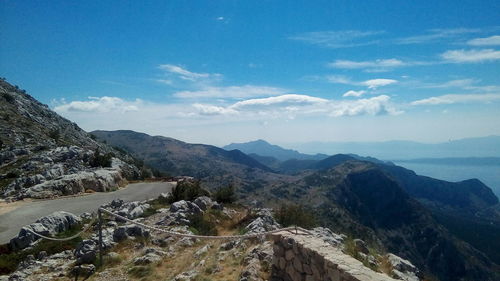 Scenic view of mountains against cloudy sky