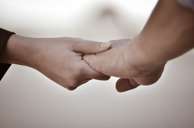 Cropped image of people holding hands