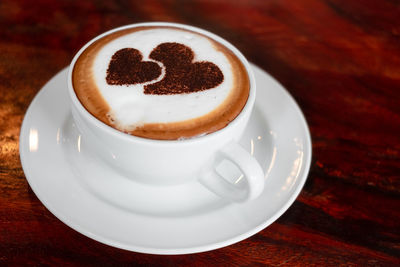 Close-up of cappuccino served on table