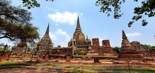 View of old temple against building