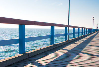 Pier over sea against clear sky