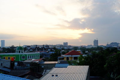 Cityscape against cloudy sky