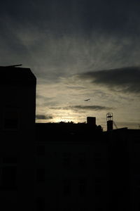 Low angle view of building against sky at sunset