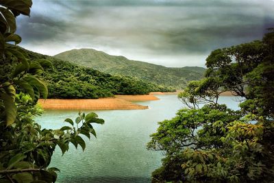 Scenic view of lake against cloudy sky