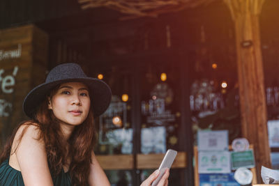 Portrait of beautiful young woman in hat