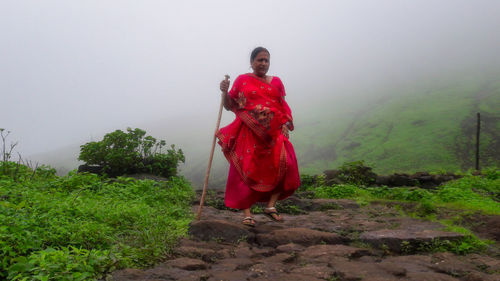 Full length of man standing on land against sky