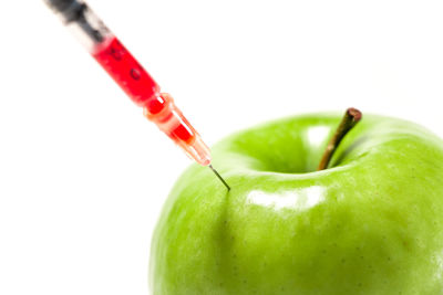 Close-up of red apple against white background