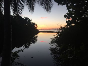 Scenic view of calm lake at sunset