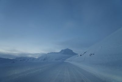 Scenic view of snow covered mountain against sky