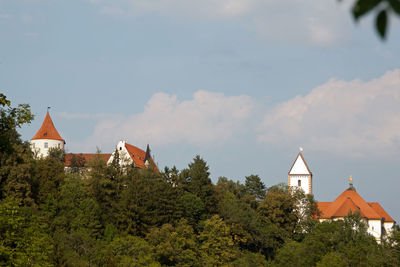 Panoramic view of trees and buildings against sky