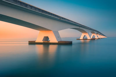 View of bridge over sea against clear sky