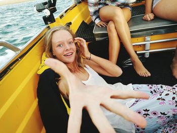 High angle portrait of smiling young woman traveling in boat