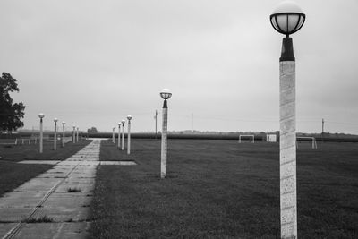 Lighting equipment on field against sky