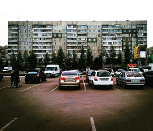 Traffic on road in city against sky