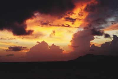 Scenic view of dramatic sky over sea during sunset