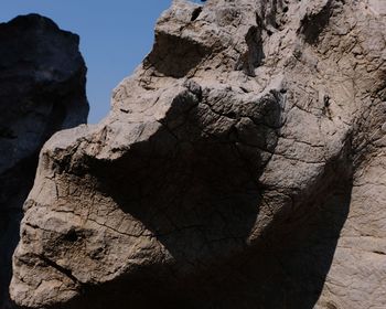 Low angle view of rock formation against sky