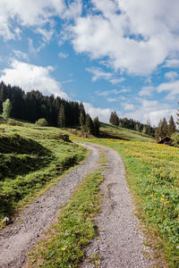 Empty road along countryside landscape