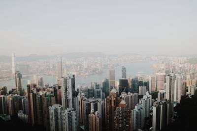 Aerial view of modern buildings in city against clear sky