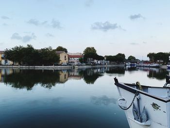 Reflection of building in lake against sky