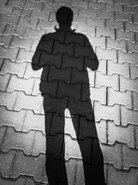 Shadow of man on footpath