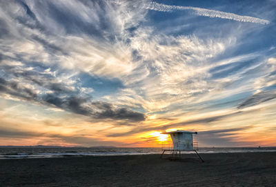 Scenic view of beach against sky during sunset