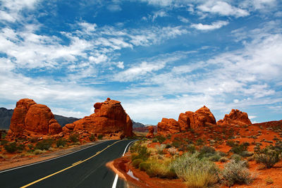 Road amidst rock formations against sky