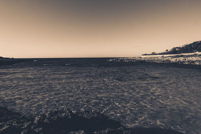 Scenic view of sea against clear sky during sunset