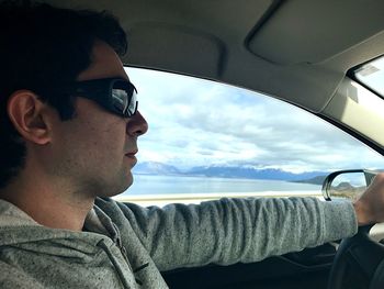 Portrait of young man in car