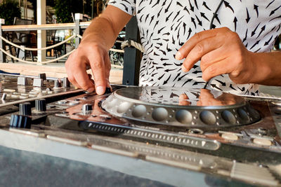 Turkey, alanya - august 12, 2022, dj's hands on mixing player close-up, on beach