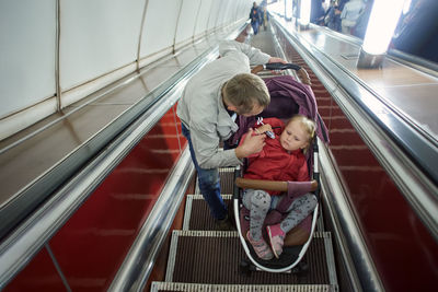 Rear view of people on escalator