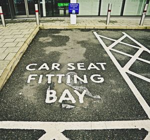 High angle view of road sign on footpath